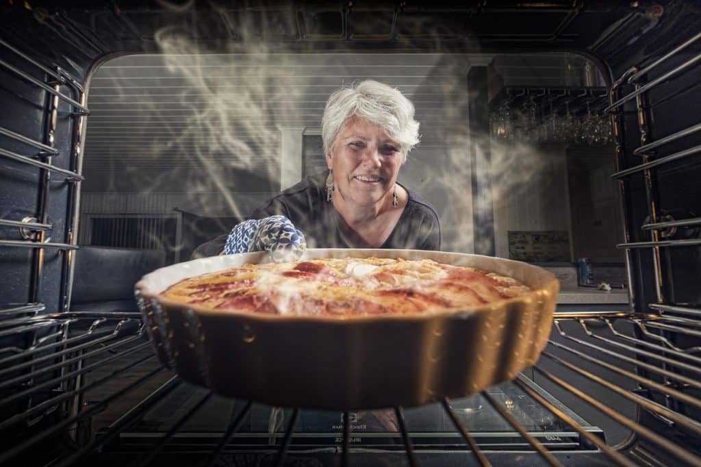 pulling baking out of oven