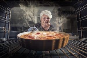 pulling baking out of oven