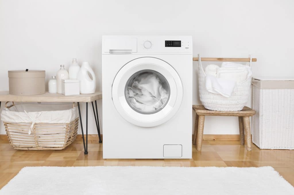 modern washing machine and laundry baskets