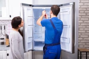 Repairman Fixing Refrigerator